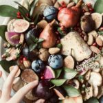 Plateau de fromages d’automne avec fruits, crackers, et noix accompagnements pour le fromage